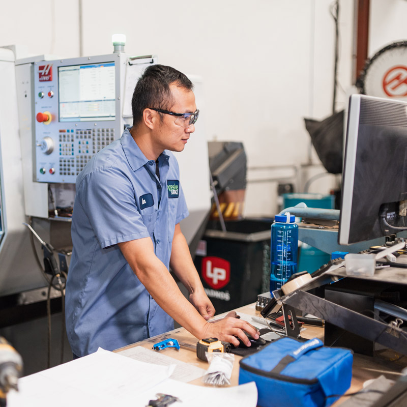 Employee working at machine | Progressive Surface