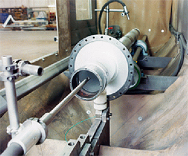 Figure 13 Peening a turbine shaft bearing journal using a deflector lance. Note that the part must rotate to provide proper coverage | Progressive Surface